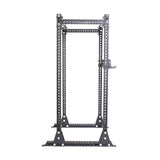 The Manticore Flat Foot Power Rack Builder by Bells of Steel is a black, freestanding unit designed for weightlifting and strength training. It boasts a 1,000-pound capacity and features multiple 1-inch holes for adjustable height settings. Constructed with a sturdy metal frame measuring 3" x 3", it offers excellent stability within an open ecosystem.
