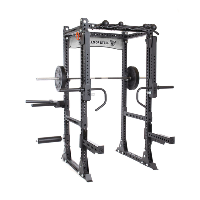 The Manticore Flat Foot Power Rack Builder, crafted from sturdy black steel and emblazoned with the "Bells of Steel" brand, serves as an open ecosystem for strength training. It is equipped with a barbell, weight plates, and versatile attachments. Featuring adjustable safety bars and pull-up bars at the top, this rack invites limitless workout possibilities.