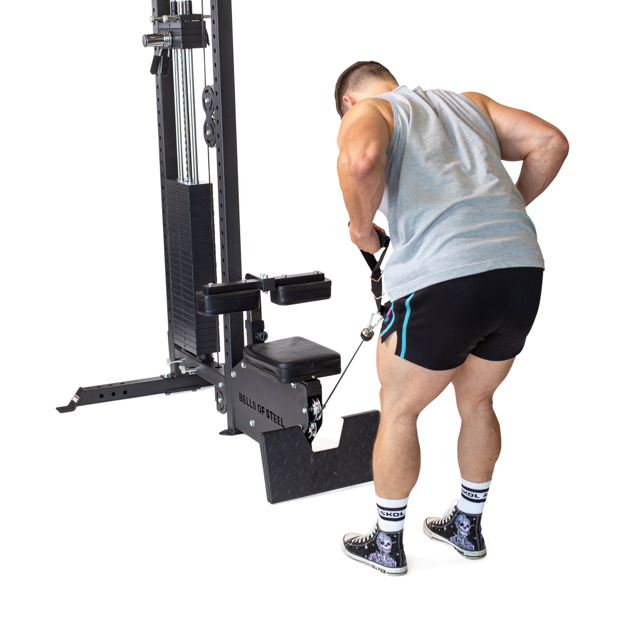 A person dressed in a tank top and shorts is using the Bells of Steel Nylon Adjustable Length Single Handle Cable Attachment to customize the cable machine for their back exercise. They pull the cable towards their body, fully focused on their workout against a plain white background.