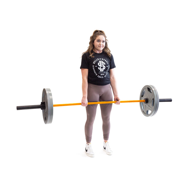 A person wearing a black T-shirt and brown leggings is seen in a powerlifting stance on a white background, gripping the Multi-Purpose Olympic Barbell – The Utility Bar by Bells of Steel, featuring gray weights at each end.