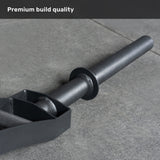 A close-up of a black barbell sleeve and collar on gray concrete highlights the premium build quality of the Bells of Steel Arch Nemesis Swiss Bar, perfect for specialty barbell training.