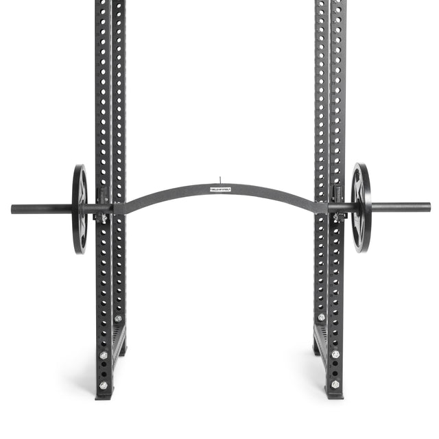 A Bells of Steel Arch Nemesis Swiss Bar, designed for versatility and safety, is loaded with weights and secured on supports in a power rack with adjustable height settings.