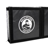 The Deadlift Platform Drop Pad Pair from Bells of Steel Canada is a black mat featuring a logo in the center that illustrates a stylized muscular figure alongside the text "BELLS OF STEEL EST. 2010." This mat is equipped with a velcro seam along the edge, designed to absorb impact and protect floors during intense workouts.