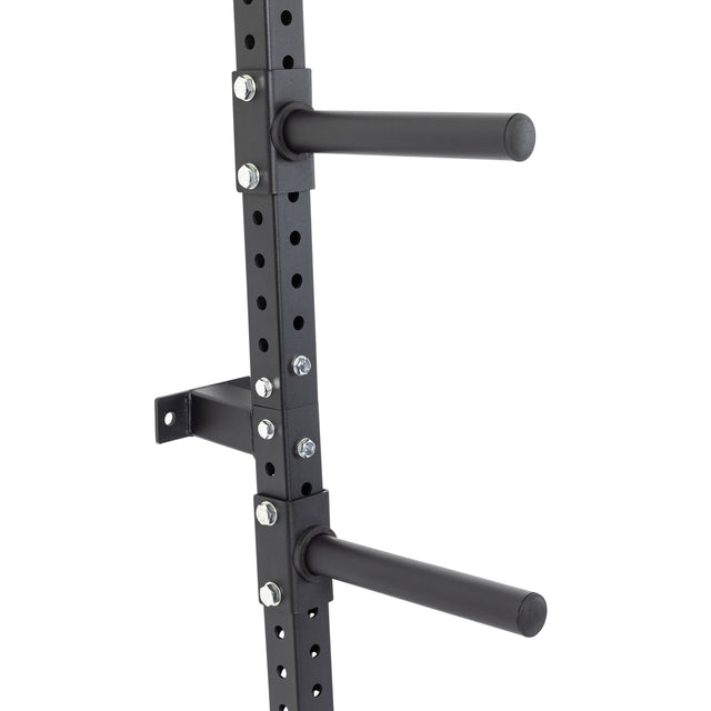 Wall-mounted rack shelves, designed to hold various sizes of weight plates.