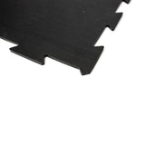 A close-up of the Bells of Steel Black Puzzle Mat, showcasing interlocking edges that allow seamless connection with other mats.