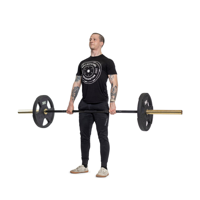 A person attired in a black T-shirt and pants is lifting a barbell equipped with ergonomic handles and Bells of Steel Canada's Rubber Coated Iron Weight Plates. They are standing on a white background, performing a deadlift exercise.