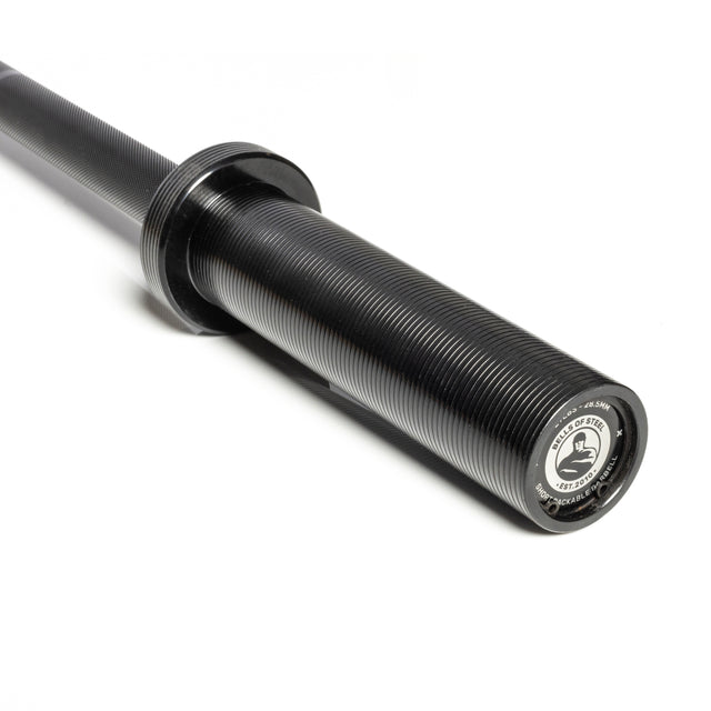 Close-up of a black ribbed sleeve with durable zinc coating on the Short Rackable Barbell by Bells of Steel, featuring a circular branded end cap. The rest of the bar is partially visible against a white background, ideal for compact home gyms.