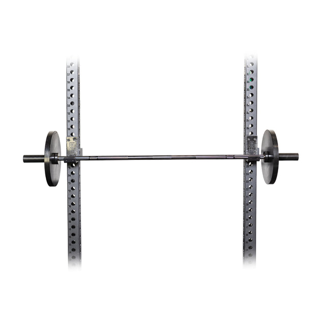 A Bells of Steel Short Rackable Barbell, featuring a durable black zinc coating, is mounted on a squat rack against a white background. The rack is ideal for space-constrained home gyms with evenly spaced holes for adjustments and perfect for squats and bench presses.