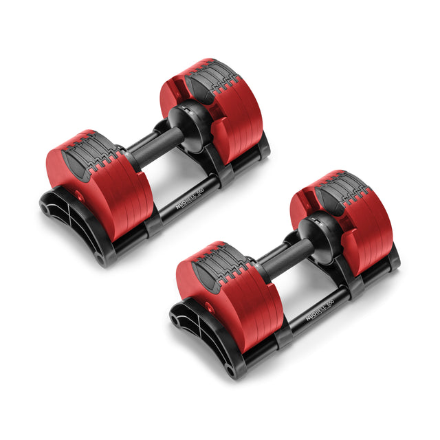 A pair of NÜOBELL Adjustable Dumbbells by Nuobell, featuring machined steel weight plates and red accents, sit side by side on a white background. The black handles rest securely on patent-pending design holders, combining functionality with sleek style.