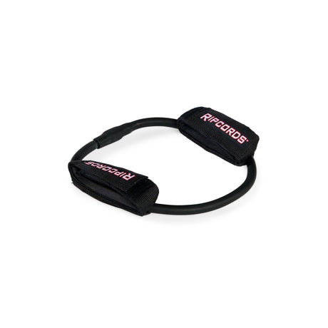 A black resistance exercise band branded “Human Trainer - Leg Cords” by Bells of Steel, featuring two padded handles labeled “RIPCORDS” in red and white, is arranged in a circular shape on a white background. This versatile band is ideal for those seeking progressive tension leg bands to enhance their strength training routine.