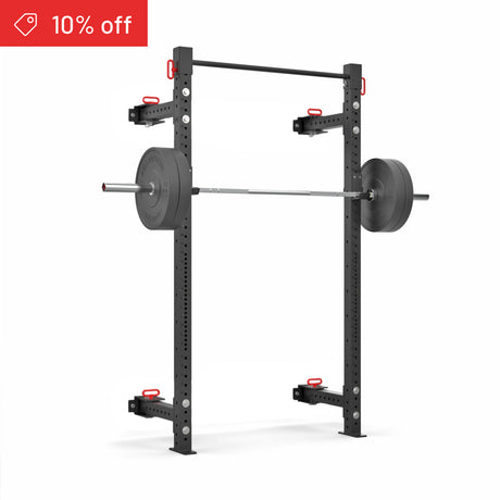 The Bells of Steel Roc Foldable 2 Post Cage Builder (3" x 3", ⅝" holes) in black with red accents stands on a white background, barbell loaded. A red banner at the top left shows “10% off”—ideal for home gyms.