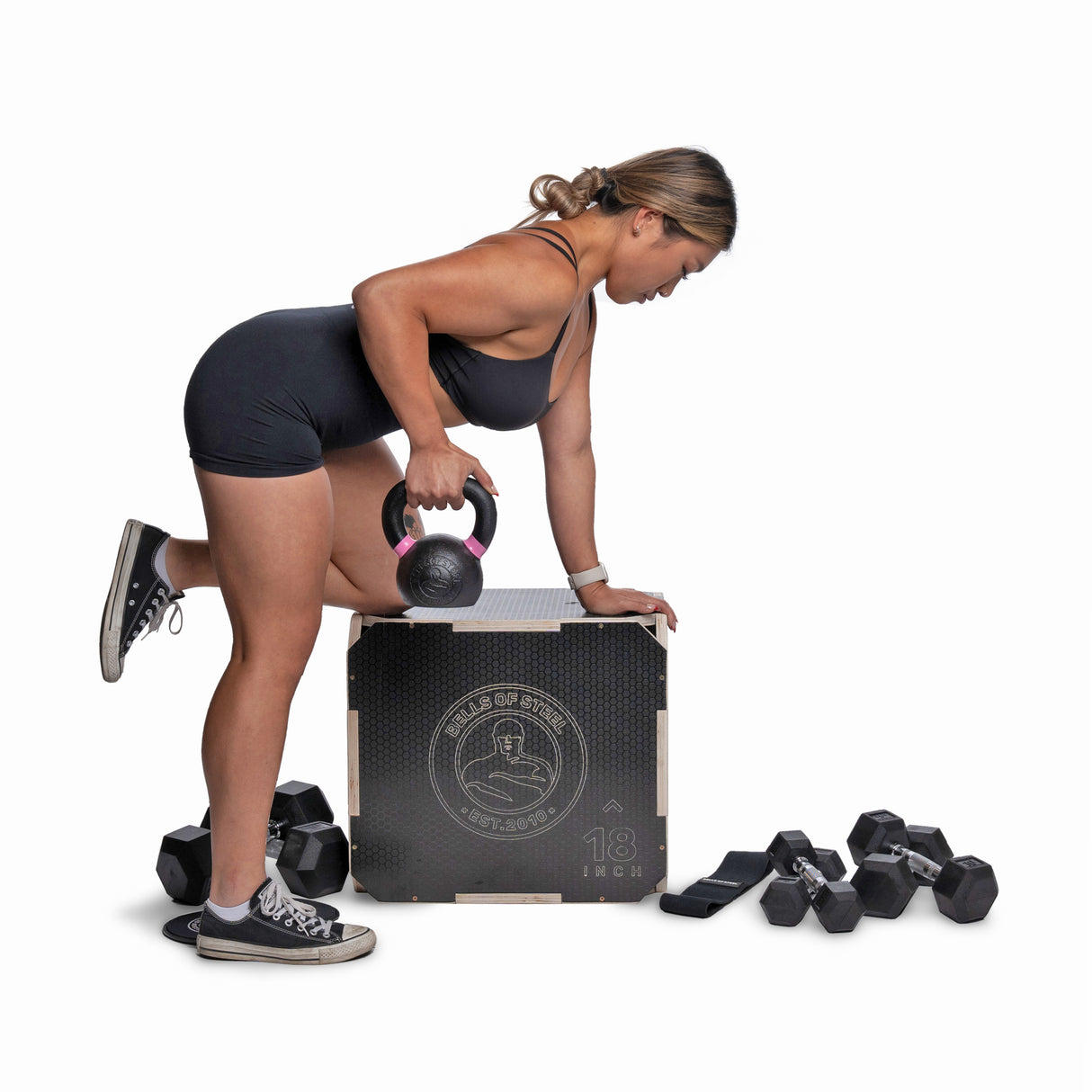 female athlete doing bent over rows with Kettlebell