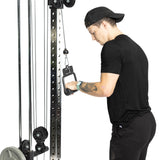 A person in a black T-shirt and cap is performing a straight bar cable curl at the gym using the Fat Bar - Single D Handle by Bells of Steel. Each controlled movement enhances grip strength, with weights and pulleys ensuring a smooth exercise experience.