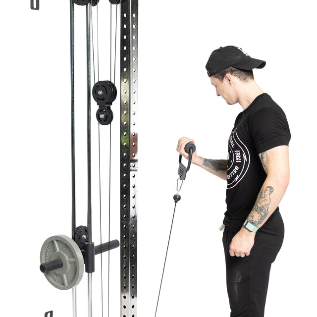 Dressed in black workout gear and a cap, a person utilizes a Bells of Steel Fat Bar - Single D Handle on a cable machine to boost grip strength during their strength training routine.