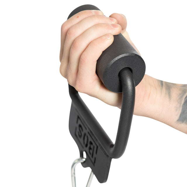 A tattooed arm grips the foam handle of a Bells of Steel Fat Bar - Single D Handle, featuring a textured black surface, attached to a carabiner on a cable machine with hanging weight, showcasing impressive grip strength.