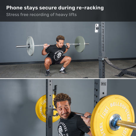 A man squats with a barbell in a gym while his phone is held nearby by the Bells of Steel Selfie Sentinel - Magnetic Rack Phone Holder. Text above reads, “Phone stays secure during re-racking. Stress free recording of heavy lifts.”.