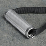 The Bells of Steel Aluminum Handles Pair with Bearings features a knurled metal grip, silver end caps, and attaches to a thick black strap, shown resting on a gray stone surface—ideal as a gym handle attachment.