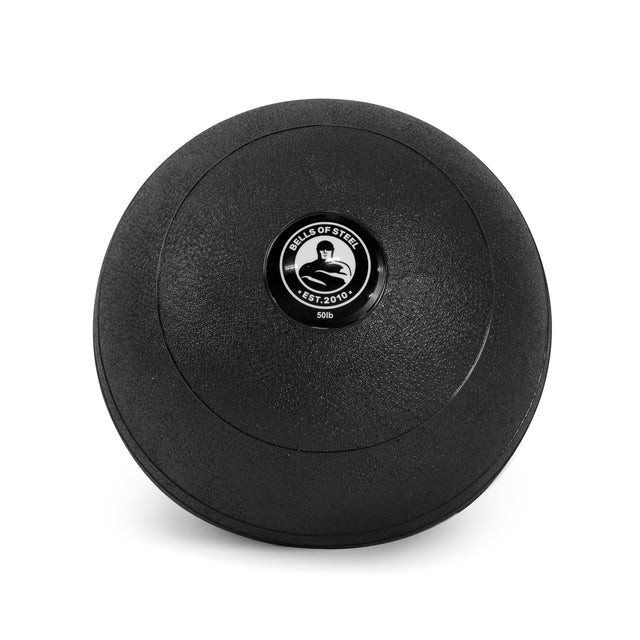 A black, round 50 lb Bells of Steel Slam Ball with a textured surface and a kettlebell logo is perfect for explosive power workouts. It features a circular emblem with "Bells of Steel," "Est. 2010" and suits intense cardio training.