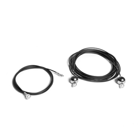 Against a white background, two coils of black replacement cables are displayed. The smaller coil includes one metallic connector, and the larger has two. Designed for Weight Stack Cable Tower needs, these durable Cables by Bells of Steel ensure reliability and strength in every strand.