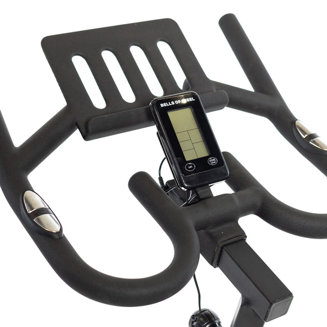 Close-up of Bells of Steel's Blitz Indoor Cycling Bike showcasing adjustable handlebars with integrated digital display, featuring small bar indicators. Curved grips have adjustment buttons, designed for comfort and control with smooth magnetic resistance.