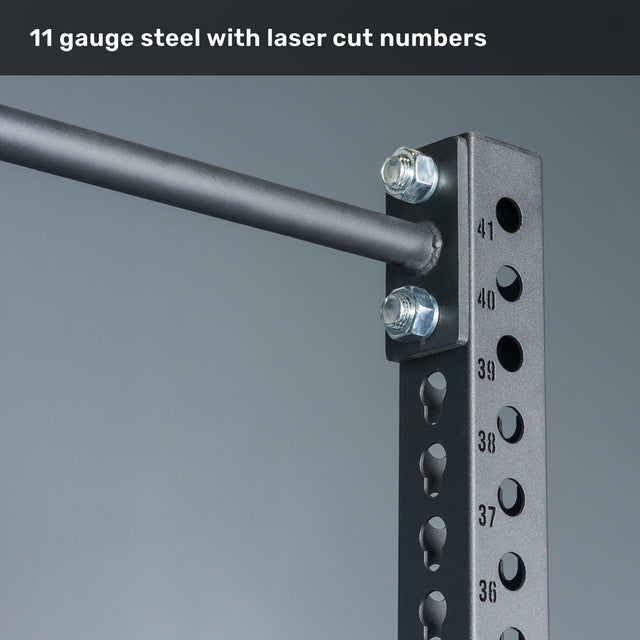 Close-up of the Bells of Steel Manticore Squat Stand Builder, featuring black 3" x 3" metal uprights with 1" holes, numbered laser-cut markings, and sturdy bolts—showcased against a gray background with "11 gauge steel with laser cut numbers" at the top. Perfect for any home gym or squat stand setup.