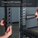 Close-up of the Bells of Steel Manticore Squat Stand’s robust 3" x 3" metal frame, showcasing precise measurement markers and attachment pins. A person’s hand secures a padded bar to the stand, demonstrating how accessories fit perfectly with the 1" holes and convenient 5/8" keyholes—an ideal choice for customizing your home gym setup.
