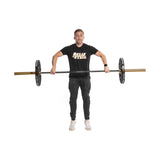 A person displays strength and precision while lifting a barbell with Technique Plates - 5 Lbs (Pair) from Bells of Steel. They're dressed in a black "Bells of Steel" t-shirt, black pants, and white sneakers, set against a plain white background to highlight their home gym setup.