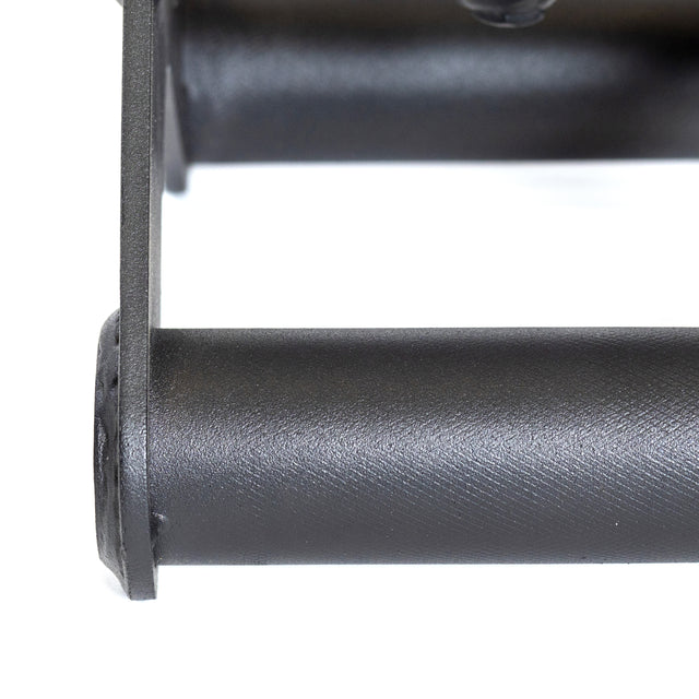 The image shows a close-up of the Bells of Steel Fat Bar, a black cylindrical metal component used as a T-Bar Row Cable Attachment. It features a smooth texture with an enhancing grip frame and versatile functionality. The background is white.