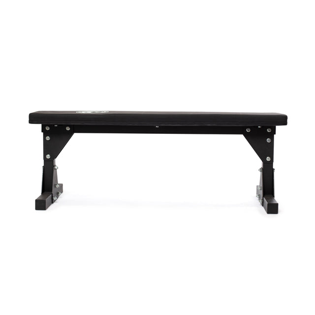 Take a look at the Flat Utility Bench by Bells of Steel—a practical black bench with a flat cushioned surface and robust metal legs, offering optimal support for exercise and gym sessions when viewed from a low angle.