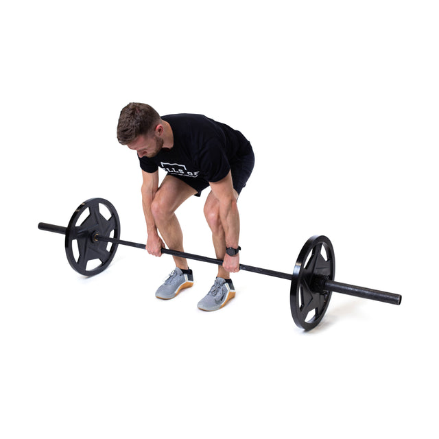 A person dressed in athletic wear is performing a deadlift with a barbell featuring Bells of Steel Black Mighty Grip Olympic Weight Plates. They are bent forward, gripping the barbell with both hands, ready to lift against a plain white background.