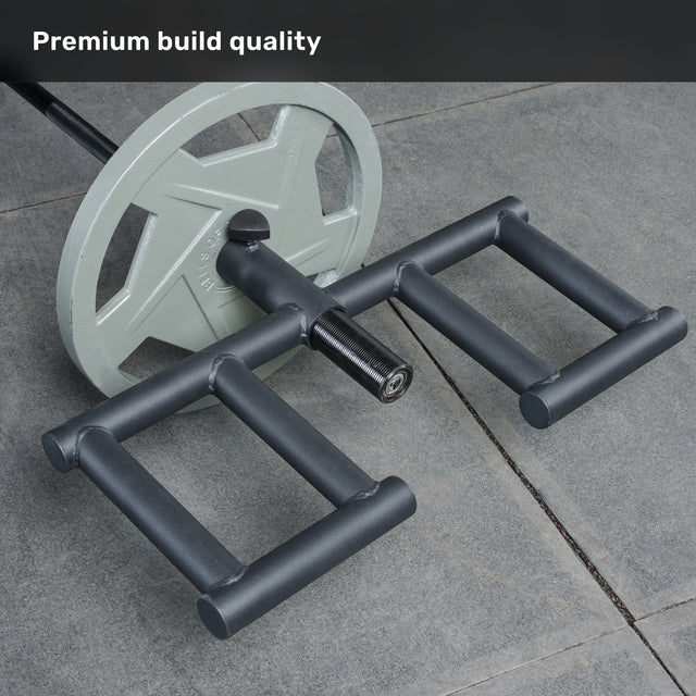 A close-up of the Bells of Steel Viking Press Attachment with large weight plates and parallel handles, lying on a concrete floor beside an Olympic bar. Text in the corner reads, "Premium build quality.