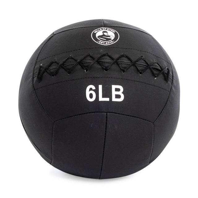 The Bells of Steel's Triple Stitched Medicine Ball is black with a Kevlar outer shell, visible logo, crisscross stitching, labeled "6 LB," and part of a collection with various weights.