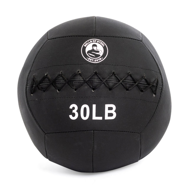 The Triple Stitched Medicine Balls from Bells of Steel have a durable Kevlar shell, black stitching, and a front logo reading "BELLS OF STEEL EST. 2010." Available in various weights with white "30LB" text, they are perfect for versatile workouts.