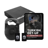 An image shows the Wildman Turkish Get Up Adjustable Kettlebell Bundle with two wristbands and an iPad for a "Turkish Get-Up Master Class." Two black Bells of Steel mats are stacked behind, highlighting the path to functional strength.