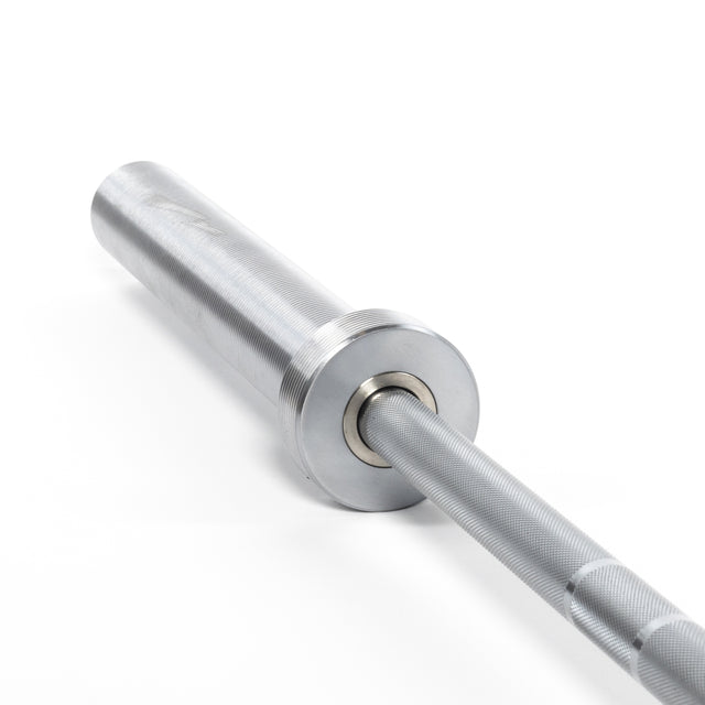 Close-up of the Bells of Steel Oly Lifting Needle Bearing Bar - Women's, featuring its silver end with detailed knurling and a smooth finish. Designed as a top Olympic weightlifting bar for women, it blends elegance with superior performance against a white background.