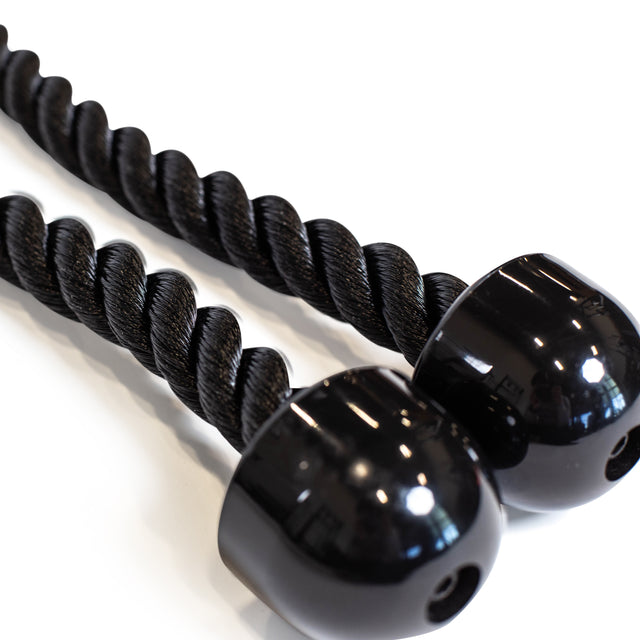 A close-up of two black braided ropes from the Bells of Steel Extra Long Tricep Rope Extension (137cm) featuring glossy black caps on their ends, resembling a cable attachment for tricep pushdowns, set against a white background.