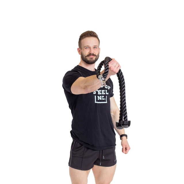 A man in a black T-shirt and shorts confidently holds a Bells of Steel Extra Long Tricep Rope Extension (137cm) against a plain white background.