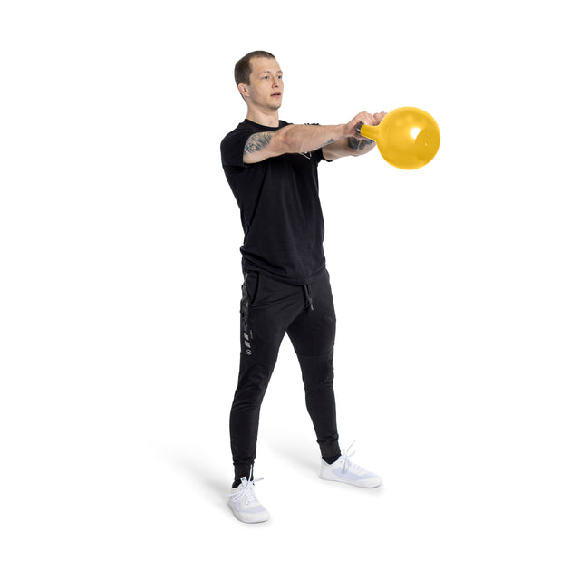 A person in a black T-shirt and pants is performing a kettlebell swing with an Adjustable Competition Kettlebell from Bells of Steel. They stand against a white background, appearing focused and maintaining good posture.