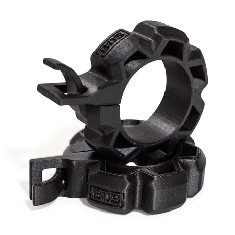 Two black Barbell Zip Clips - Half Standard (Pair) by Bells of Steel are stacked together, featuring rugged plastic build, gear-like edges, hooks, and "EOS" embossed on the surface.