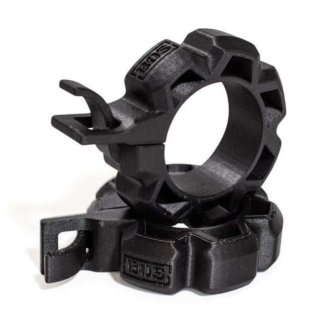 Two black Barbell Zip Clips - Half Standard (Pair) by Bells of Steel are stacked together, featuring rugged plastic build, gear-like edges, hooks, and "EOS" embossed on the surface.