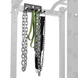 The Bells of Steel Accessory Holder (Wall or Rack Mounted) neatly stores two heavy chains, a green resistance band, and a black weightlifting belt on hooks, with part of the rack frame visible in the background.