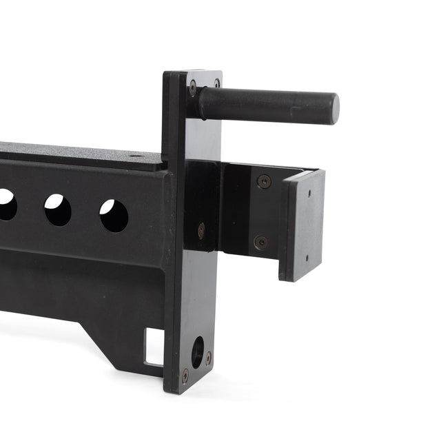 A close-up of the Bells of Steel Spotter Arms Rack Attachment shows a durable black metal adjustable bracket with heavy-duty features like a handle, multiple holes, a bolt, and an attachment point for mounting or supporting equipment.