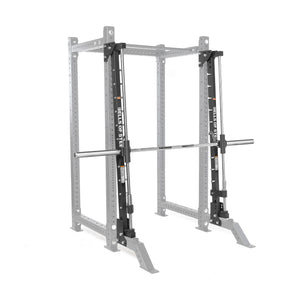 The Bells of Steel Smith Machine Rack Attachment, shown in silver with a barbell, is designed for weightlifting and strength training. The equipment is displayed against a plain white background.