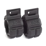 The Barbell Zip Clips from Bells of Steel are black rubber grip collars with a pressure-cuff design, "BOS" engraved on each. They feature a textured surface and a locking mechanism to securely hold weights on a barbell.