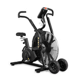 The Bells of Steel Blitz Max Air Bike is a black, high-performance fitness machine with large front fan wheels. Two detachable all-terrain transport wheels beside it make moving easy, making it perfect for any commercial gym.