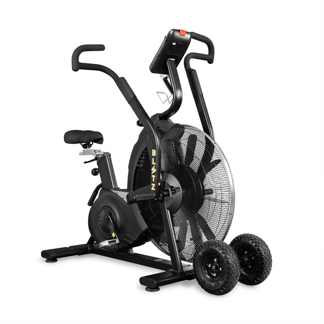 The Bells of Steel Blitz Max Air Bike is a black, high-performance fitness machine with large front fan wheels. Two detachable all-terrain transport wheels beside it make moving easy, making it perfect for any commercial gym.