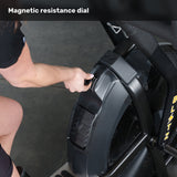 A person adjusts the magnetic resistance dial on the Bells of Steel Blitz Max Air Bike. The image highlights the hand on the dial and the fan system, showcasing premium fitness equipment for any commercial gym. Text at top: "Magnetic resistance dial.