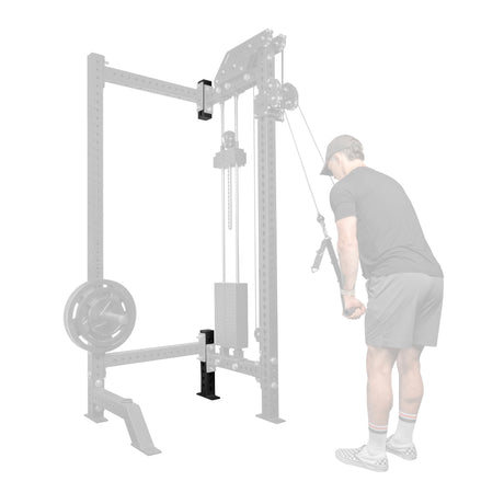A man in athletic wear does a cable tricep pushdown on a machine equipped with Bells of Steel 3" x 3" Rack Junctions, offering customization for any home gym. He faces the machine, gripping handles with both hands and elbows tucked in.