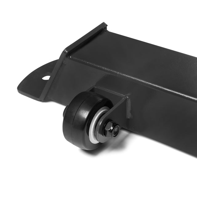 Close-up of a black metal bracket with a small wheel, bolt, and washer assembly—key hardware for the Bells of Steel Buzz-Saw Heavy-Duty Adjustable Bench. Shown on a white background to highlight its sturdy construction.