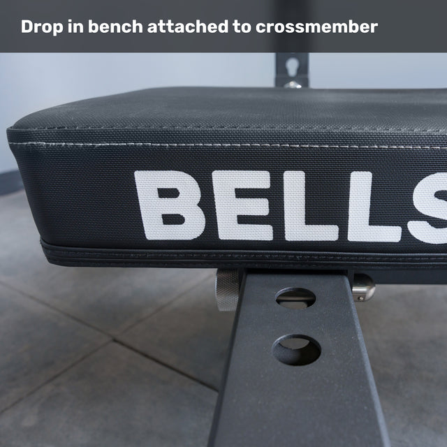 Close-up of the Bells of Steel Crossmember For Converter Bench - 43" attached to a bench with adjustment holes. Caption reads, "Drop in bench attached to crossmember." An ideal addition for your rack setup.